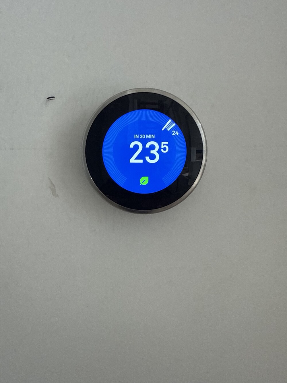 Smart wireless thermostat displaying the home heating temperature